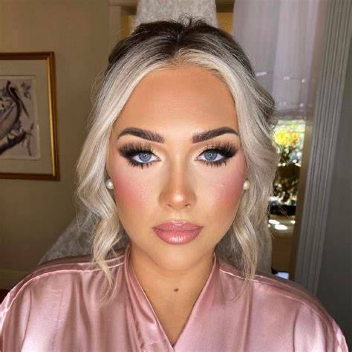 Full glam: Her hair was styled in a high bun and she rocked a dramatic black smokey eyeshadow look with a nude lip